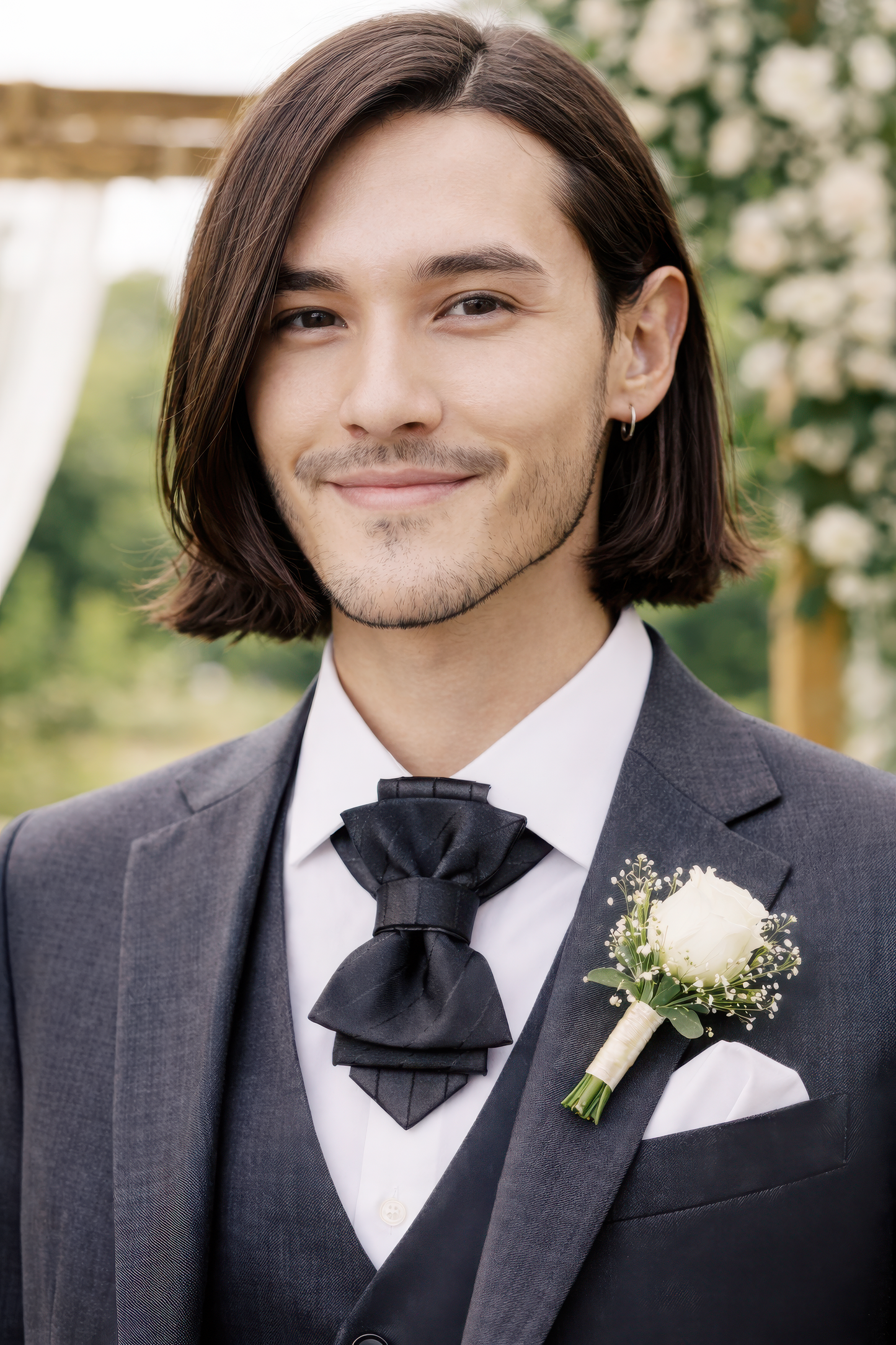 Man in a gray suit with a black bow tie and white flower boutonniere, standing outdoors handmade black bow tie for men, black wedding bow tie for groom, unique black statement bow tie, luxury handmade black bow tie, designer black bow tie men, modern black wedding bow tie, artistic black bow tie design, groom statement bow tie black, black formal bow tie unisex, alternative black bow tie style, creative handmade black neckwear, stylish black bow tie events, elegant modern black bow tie, fashion forward blac