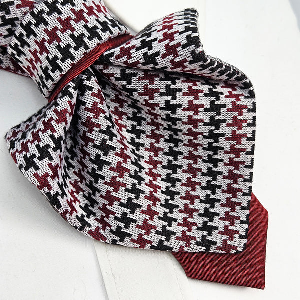 Houndstooth patterned bow tie with red accents on a white background premium handmade knitted houndstooth tie in burgundy, luxury italian silk wool blend necktie with red pied-de-poule pattern, unique red and black patterned tie for wedding or business attire, close-up of high-quality wool knit scarf style tie with abstract design, elegant burgundy and black dogtooth patt