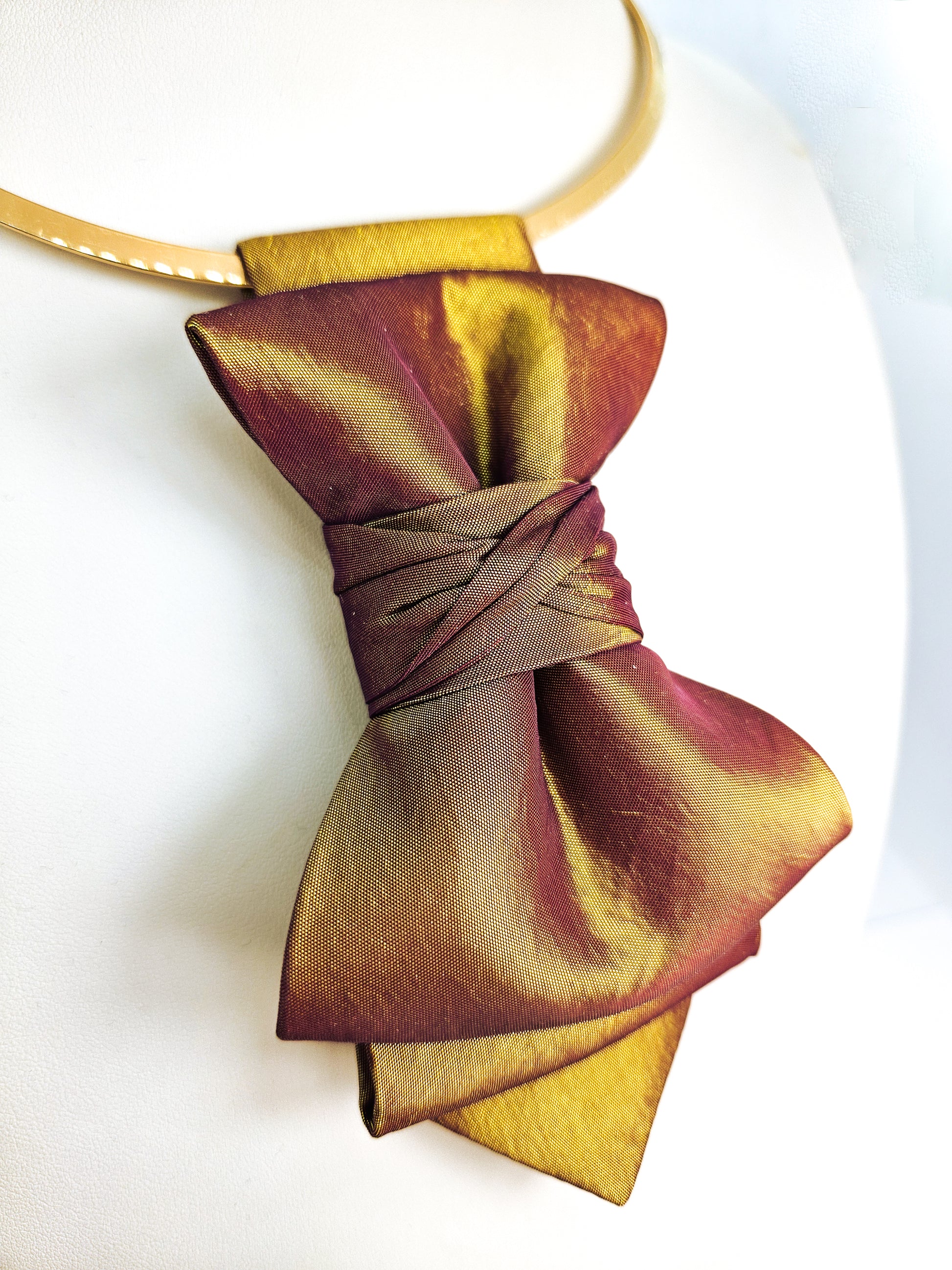 Gold and purple bow tie on a white background metallic plum gold womens necktie, bronze burgundy metallic bow tie for women, chameleon fabric neck accessory, handmade statement necktie, sculptural womens neckwear, metallic plum bronze neckpiece, luxury handmade womens neck accessory, artistic fabric necktie, modern designer womens bow tie, elegant metallic neckwear, unique womens fashion necktie, gold burgundy neck accessory, contemporary statement neckpiece