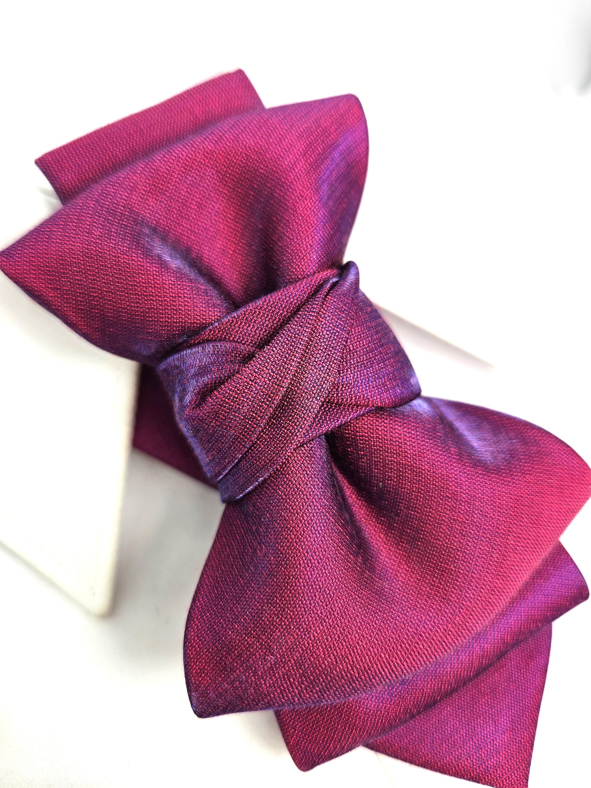 Purple fabric bow on a white background fashionable, elegant, sophisticated, chic, modern, unique, exclusive, luxurious, high-end, premium, quality, handmade, artisan, bespoke, tailored, custom, designer, trendy, vogue, modish, smart, classy, stylish, fashion-forward, contemporary, women's fashion, ladies' wear, apparel, clothing, attire, garment, outfit, ensemble, get-up, dress, gown, frock, top, blouse, shirt, sweater, jacket, coat, blazer, skirt, trousers, pants, jeans, shorts, leggings, jumpsuit, romper