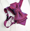 Purple bow tie on a white shirt with a blurred background Handmade luxury fashion neck accessory, women's necktie accessory, purple satin necktie choker, gold choker with fabric tie, elegant women's neckwear, unique fashion accessory, stylish purple necktie for women, luxury handmade choker, modern neck accessory for women, fashionable women's tie necklace, chic and sophisticated neckpiece, bespoke fabric tie, artisan crafted neckwear, high-end ladies' accessory, formal women's tie, statement neck accessory