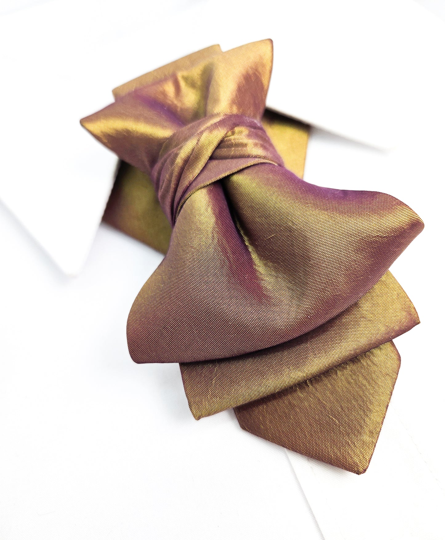 Gold and purple bow tie on a white background metallic plum gold womens necktie, bronze burgundy metallic bow tie for women, chameleon fabric neck accessory, handmade statement necktie, sculptural womens neckwear, metallic plum bronze neckpiece, luxury handmade womens neck accessory, artistic fabric necktie, modern designer womens bow tie, elegant metallic neckwear, unique womens fashion necktie, gold burgundy neck accessory, contemporary statement neckpiece