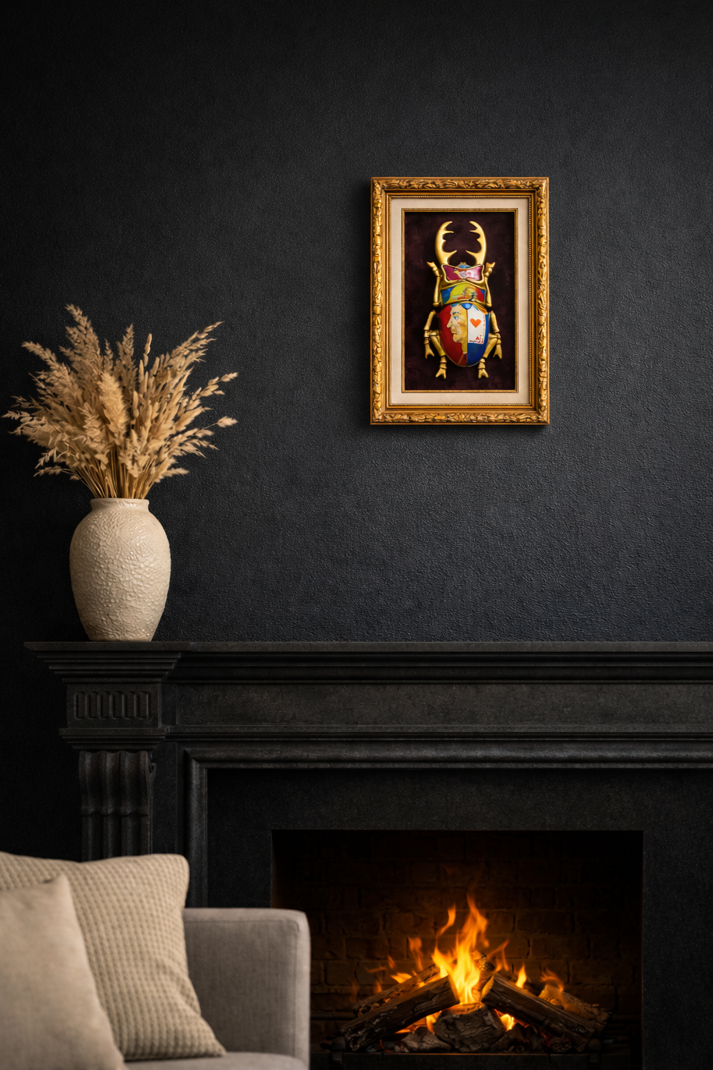 Framed artwork above a fireplace with a vase of pampas grass on a dark wall.