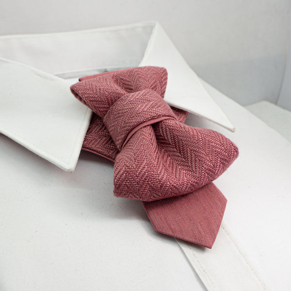 Pink knitted bow tie on a white shirt collar
