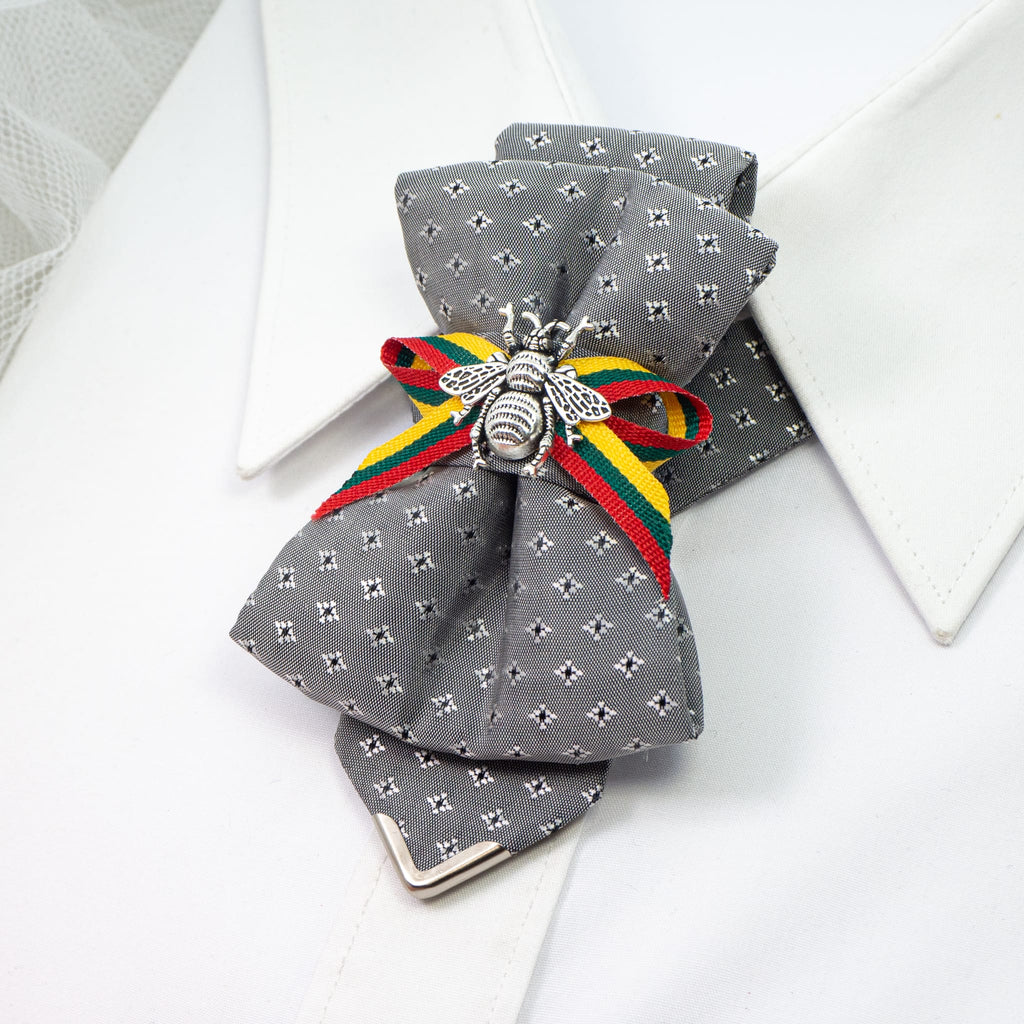 Bow tie "Bitute pilkoji" is a work, dedicated to the birthday of Vilnius, the capital of Lithuania.  Brass Vytis adorns the original knot of three fabrics. Keistas kaklaraištis, nematyta peteliškė, Vilniaus kaklaraištis, Kaklaraištis žiogas, keista varlytė