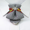 Bow tie "Bitute pilkoji" is a work, dedicated to the birthday of Vilnius, the capital of Lithuania.  Brass Vytis adorns the original knot of three fabrics. Keistas kaklaraištis, nematyta peteliškė, Vilniaus kaklaraištis, Kaklaraištis žiogas, keista varlytė