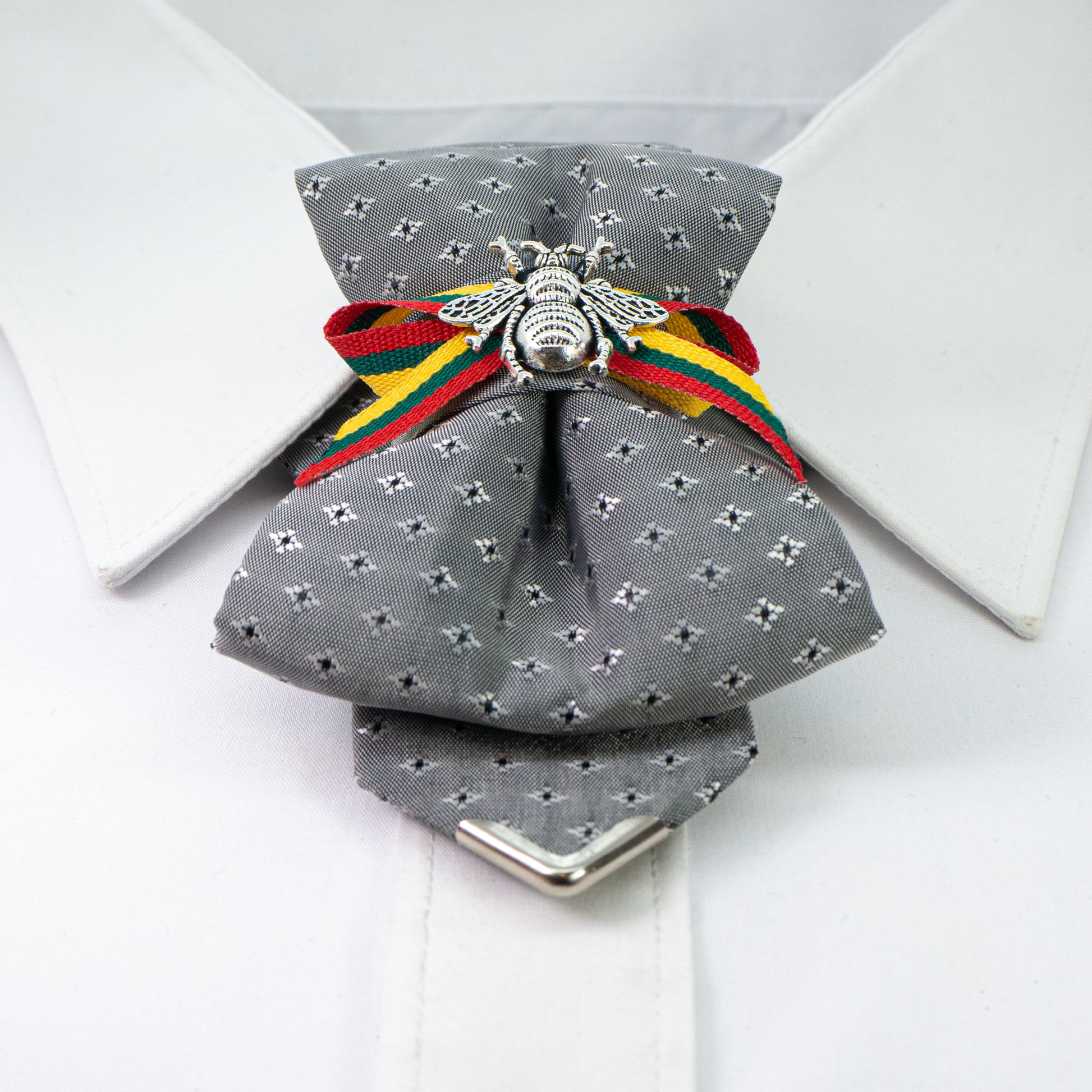 Bow tie "Bitute pilkoji" is a work, dedicated to the birthday of Vilnius, the capital of Lithuania.  Brass Vytis adorns the original knot of three fabrics. Keistas kaklaraištis, nematyta peteliškė, Vilniaus kaklaraištis, Kaklaraištis žiogas, keista varlytė