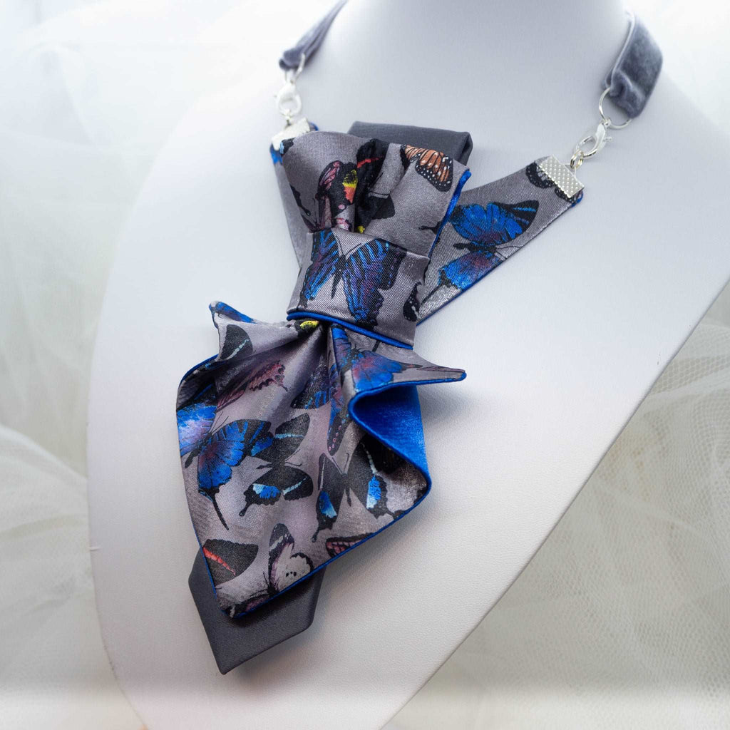 Jabot Blue tie for women, Blue bow tie for ladies side view Handmade luxury women’s necktie “Butterfly” – elegant gray and blue accessory with butterfly pattern, combining tie and bow style, perfect for weddings, musicians, and artistic women.Jabot blue tie for women, blue bow tie for ladies, handmade luxury women’s necktie, butterfly jabot tie, gray and blue butterfly pattern tie, artistic women’s neck accessory, statement bow tie for women, sculptural fabric tie accessory, modern jabot necklace tie, elega