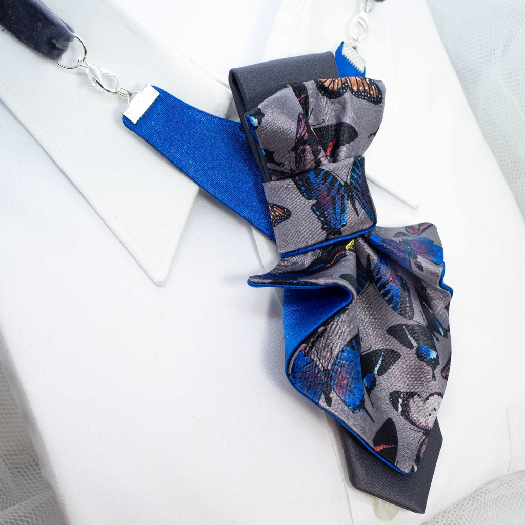 Jabot Blue tie for women, Blue bow tie for ladies side view Jabot blue tie for women, blue bow tie for ladies, handmade luxury women’s necktie, butterfly jabot tie, gray and blue butterfly pattern tie, artistic women’s neck accessory, statement bow tie for women, sculptural fabric tie accessory, modern jabot necklace tie, elegant women’s tie for weddings, unique designer necktie for women, butterfly print fashion accessory, avant garde women’s tie, luxury handmade tie Lithuania, Rūta Piekurienė design tie, 