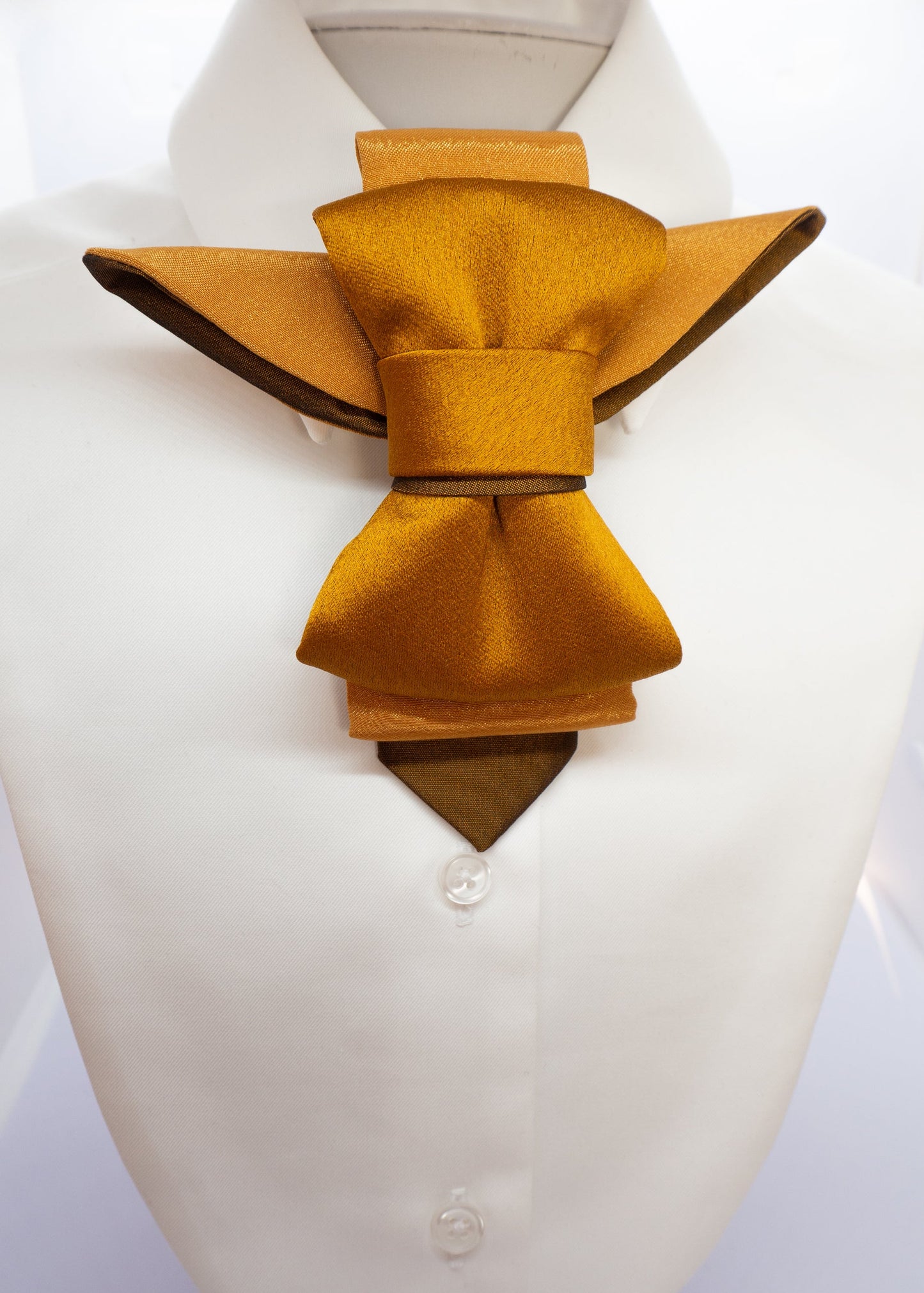 A unique vertical women's bow tie in mustard yellow, HOPPER TIE BRASS BIRD created by Ruty design, Hopper tie, Bow Tie, handmade luxury neck accessory, women statement tie, vertical bow tie for women, gold satin necktie, elegant women tie, unique bow tie alternative, luxury handmade tie, artistic neckwear for women, modern formal accessory, gold statement necklace tie, designer women necktie, wedding guest accessory women, avant garde fashion tie, silk bow tie alternative, bold women fashion accessory, gold