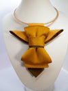 A unique vertical women's bow tie in mustard yellow handmade luxury neck accessory, women statement tie, vertical bow tie for women, gold satin necktie, elegant women tie, unique bow tie alternative, luxury handmade tie, artistic neckwear for women, modern formal accessory, gold statement necklace tie, designer women necktie, wedding guest accessory women, avant garde fashion tie, silk bow tie alternative, bold women fashion accessory, golden necktie women, formal outfit statement piece stylish office acces