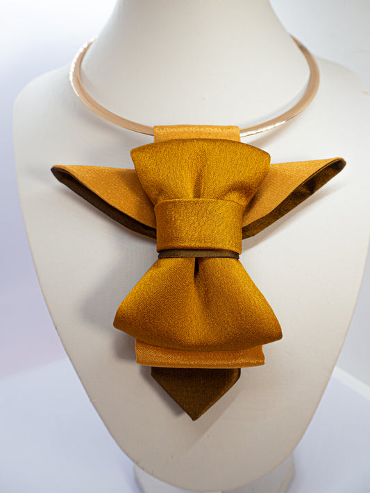 A unique vertical women's bow tie in mustard yellow handmade luxury neck accessory, women statement tie, vertical bow tie for women, gold satin necktie, elegant women tie, unique bow tie alternative, luxury handmade tie, artistic neckwear for women, modern formal accessory, gold statement necklace tie, designer women necktie, wedding guest accessory women, avant garde fashion tie, silk bow tie alternative, bold women fashion accessory, golden necktie women, formal outfit statement piece stylish office acces