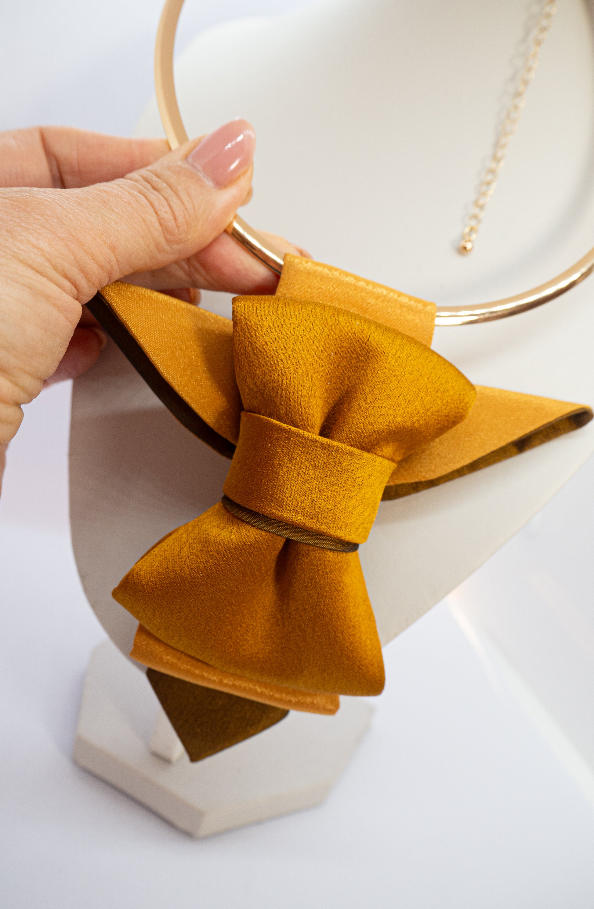 A unique vertical women's bow tie in mustard yellow, HOPPER TIE BRASS BIRD created by Ruty design, Hopper tie, Bow Tie handmade luxury neck accessory, women statement tie, vertical bow tie for women, gold satin necktie, elegant women tie, unique bow tie alternative, luxury handmade tie, artistic neckwear for women, modern formal accessory, gold statement necklace tie, designer women necktie, wedding guest accessory women, avant garde fashion tie, silk bow tie alternative, bold women fashion accessory, golde