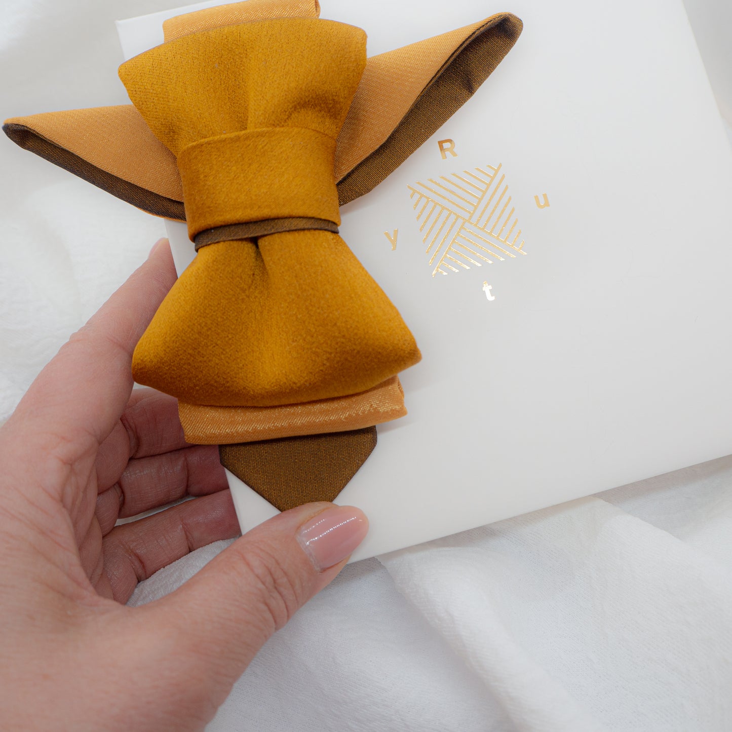 A unique vertical women's bow tie in mustard yellow handmade luxury neck accessory, women statement tie, vertical bow tie for women, gold satin necktie, elegant women tie, unique bow tie alternative, luxury handmade tie, artistic neckwear for women, modern formal accessory, gold statement necklace tie, designer women necktie, wedding guest accessory women, avant garde fashion tie, silk bow tie alternative, bold women fashion accessory, golden necktie women, formal outfit statement piece stylish office acces