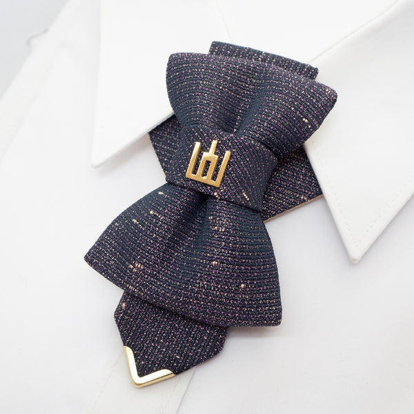 Navy blue textured bow tie with gold accents on a white background Exclusive handmade jabot necktie in shimmering black with gold and purple details, accented with Gediminas Pillars symbol. Luxury wedding tie for groom or guest, perfect accessory for cultural gatherings, ceremonies, and elegant evening wear. Unique artisan craftsmanship, high-quality Lithuanian design.