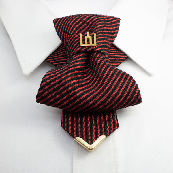 Red and black striped tie with gold clasp on a white background red black striped jabot tie, gold Gedimino stulpai emblem, handmade heritage necktie, Lithuanian cultural fashion, artisan jabot-style tie, elegant striped tie gold badge, luxury heritage necktie, cultural fashion accessory, Lithuanian identity tie, formal jabot tie, handcrafted Lithuanian motif tie