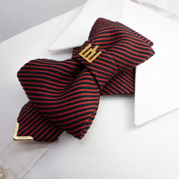 Red and black striped bow tie with gold clasp on a white shirt red black striped jabot tie, gold Gedimino stulpai emblem, handmade heritage necktie, Lithuanian cultural fashion, artisan jabot-style tie, elegant striped tie gold badge, luxury heritage necktie, cultural fashion accessory, Lithuanian identity tie, formal jabot tie, handcrafted Lithuanian motif tie