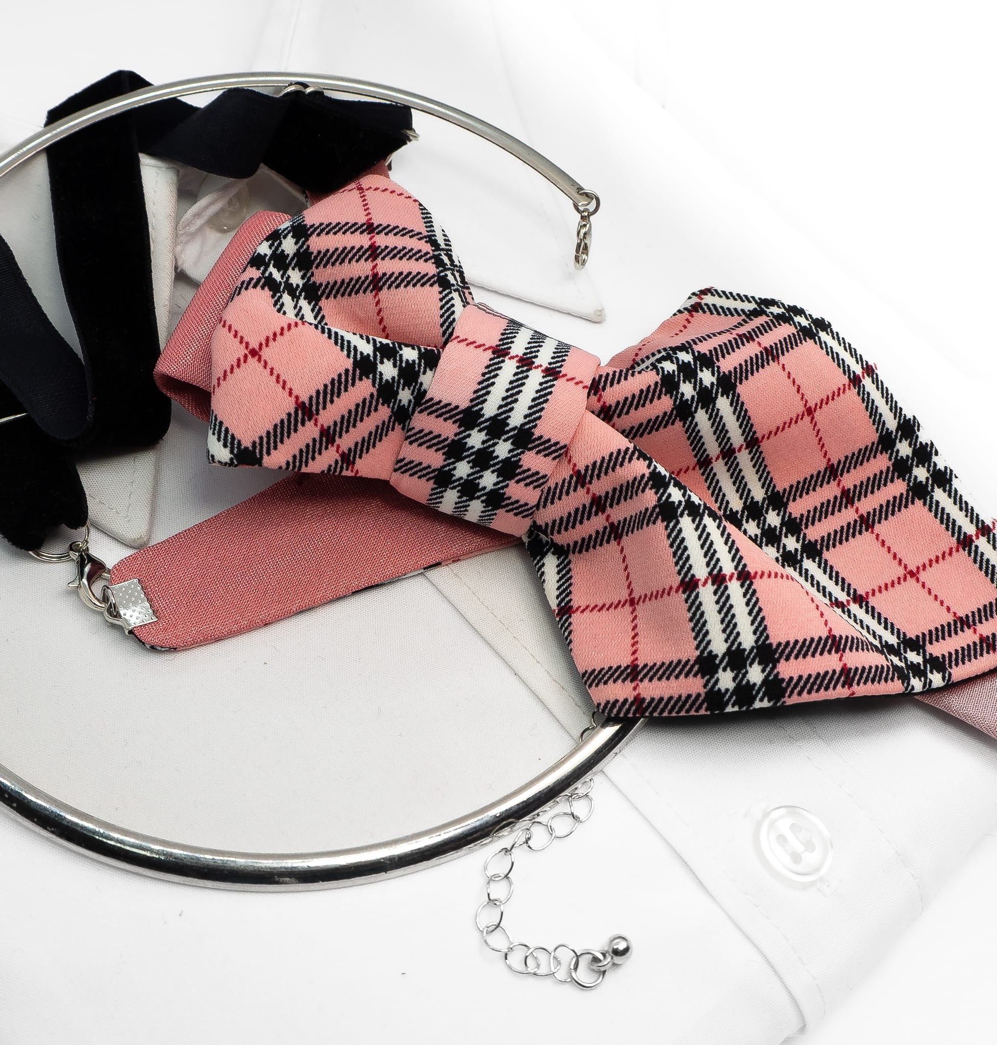 Pink plaid bow tie with a black and white pattern on a white surface Handmade luxury women’s necktie accessory in pink plaid design, unique wedding and special occasion neckwear, elegant fashion statement tie, modern alternative to bow tie, handcrafted designer accessory for bride, bridesmaid, or stylish guest, exclusive feminine neck accessory, chic and artistic neckwear gift, original handmade women’s fashion detail for parties, events, and luxury outfits.