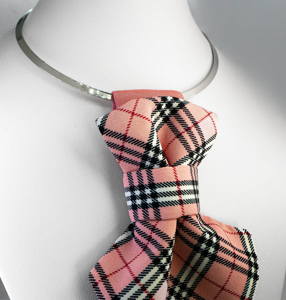 Pink plaid bow tie on a mannequin neck against a white background Handmade luxury women’s necktie accessory in pink plaid design, unique wedding and special occasion neckwear, elegant fashion statement tie, modern alternative to bow tie, handcrafted designer accessory for bride, bridesmaid, or stylish guest, exclusive feminine neck accessory, chic and artistic neckwear gift, original handmade women’s fashion detail for parties, events, and luxury outfits.