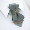 Hopper tie, Vytis tie, Vytis summer tie, green bow tie, Lithuanian necktie, handmade luxury tie, elegant necktie, unisex bow tie, adjustable strap tie, satin rayon necktie, gold grid tie, cultural tie, symbolic necktie, Ruty design, Rūta Piekurienė tie, knight symbol tie, Lithuanian knight accessory, brass Vytis emblem, statement bow tie, wedding necktie, national pride tie, artistic bow tie, men's fashion tie, women's formal tie, historical motif tie, green and gold necktie, handcrafted Lithuanian tie