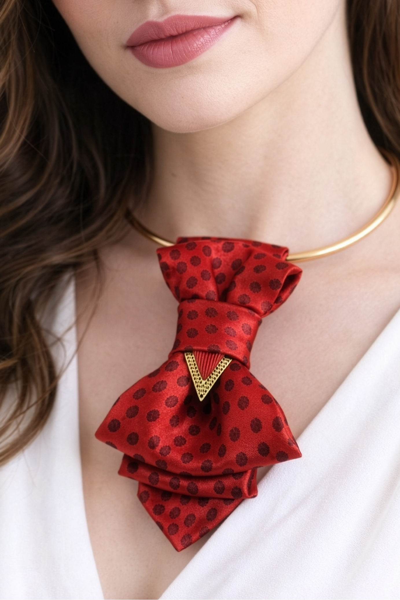 Woman wearing a red bow tie with black polka dots on a plain red bow tie necklace, handmade red neck accessory, women statement necklace, polka dot bow tie necklace, elegant women neckwear, silk bow necklace for women, artistic neck accessory, modern women jewelry, red necklace with gold detail, unique handmade jewelry, casual elegant necklace, fashion accessory for women, minimalist outfit necklace, designer bow tie necklace, women gift idea, French style jewelry, everyday statement necklace, artbackground