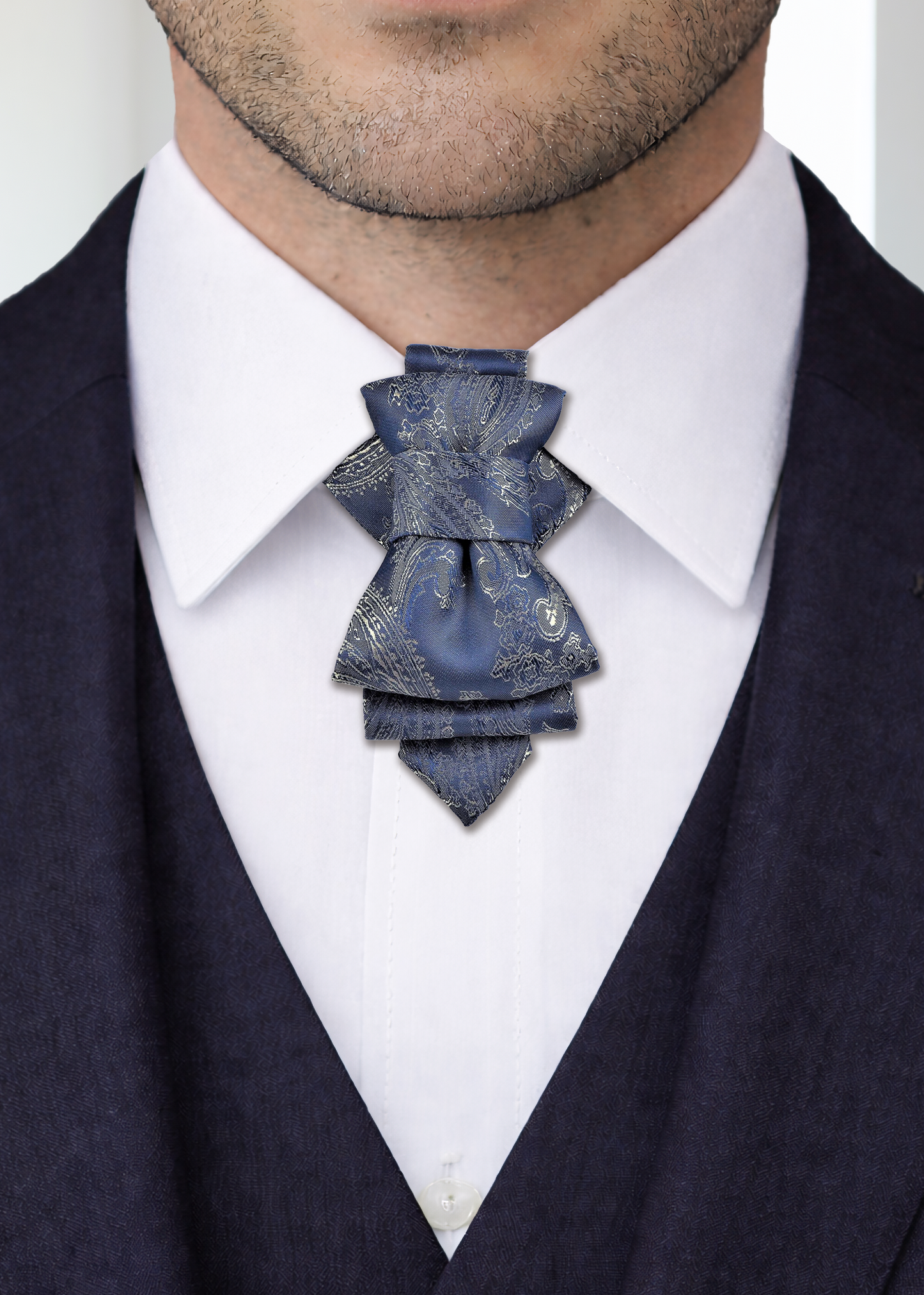 uxury handmade ascot tie close up, navy blue paisley ascot tie, silk ascot tie on white shirt, men formal neckwear detail, elegant cravat tie front view, artisan made ascot tie, premium men neck accessory, wedding groom ascot tie, stage performer formal tie, unique paisley necktie texture, luxury menswear accessory closeup, sophisticated formal tie design