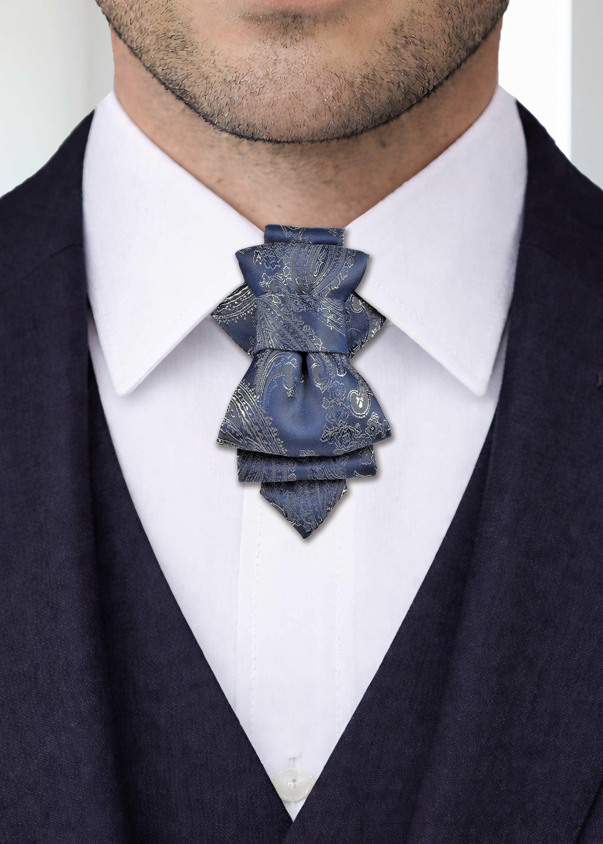 uxury handmade ascot tie close up, navy blue paisley ascot tie, silk ascot tie on white shirt, men formal neckwear detail, elegant cravat tie front view, artisan made ascot tie, premium men neck accessory, wedding groom ascot tie, stage performer formal tie, unique paisley necktie texture, luxury menswear accessory closeup, sophisticated formal tie design