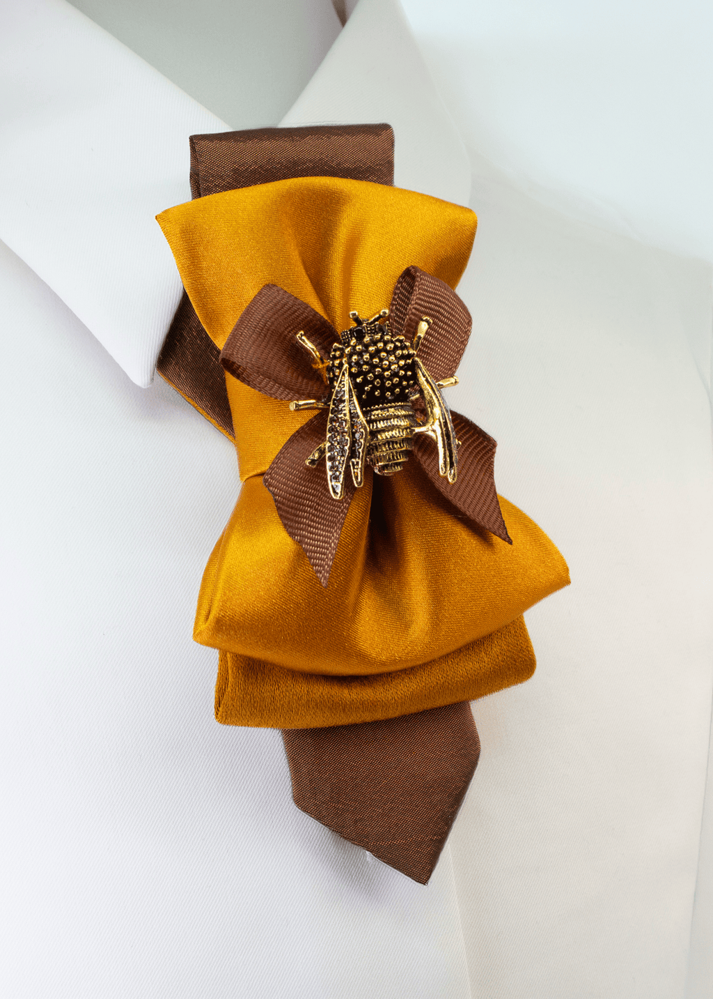 Formal gold bow tie for women styled on a white shirt collar for a professional look
