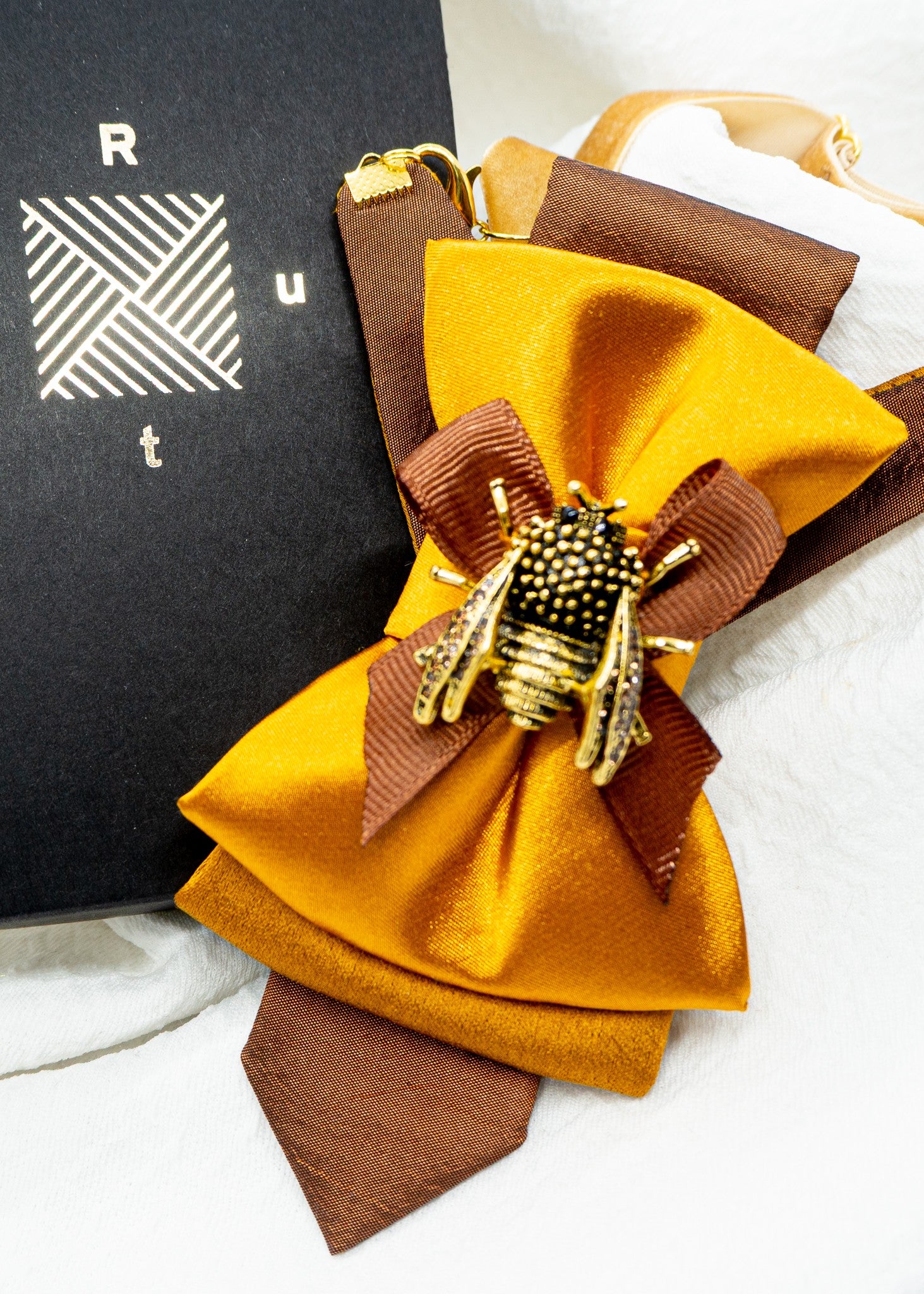 The Golden Bumblebee bow tie for women in a luxury Ruty Design gift box.