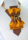 Gold-toned women's necktie with a golden bumblebee brooch and velvet strap