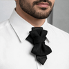 Man wearing a white shirt with a black bow tie against a neutral  Handmade black hopper tie for wedding, original designer bow tie on white shirt, Luxury black wedding hopper tie, modern bow tie and necktie hybrid, Elegant handmade hopper tie for groom, minimalist black formal accessory, Original design black hopper tie, premium wedding bow tie for men, Modern black hopper tie for formal wear, handcrafted wedding neck accessory, Designer handmade hopper tie, sophisticated black tiebackground