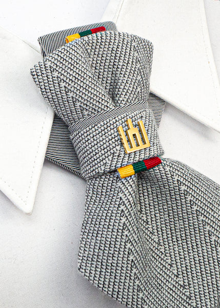 handmade luxury wedding necktie, vertical bow tie, Lithuanian Gedimino Stulpai pin, silver patterned tie, unisex formal accessory, unique design neckwear, groom tie, national symbol fashion, elegant menswear, statement necktie, artistic bow tie, heritage inspired tie, luxury gift for him or her Gray textured tie with colorful clasp on a white background