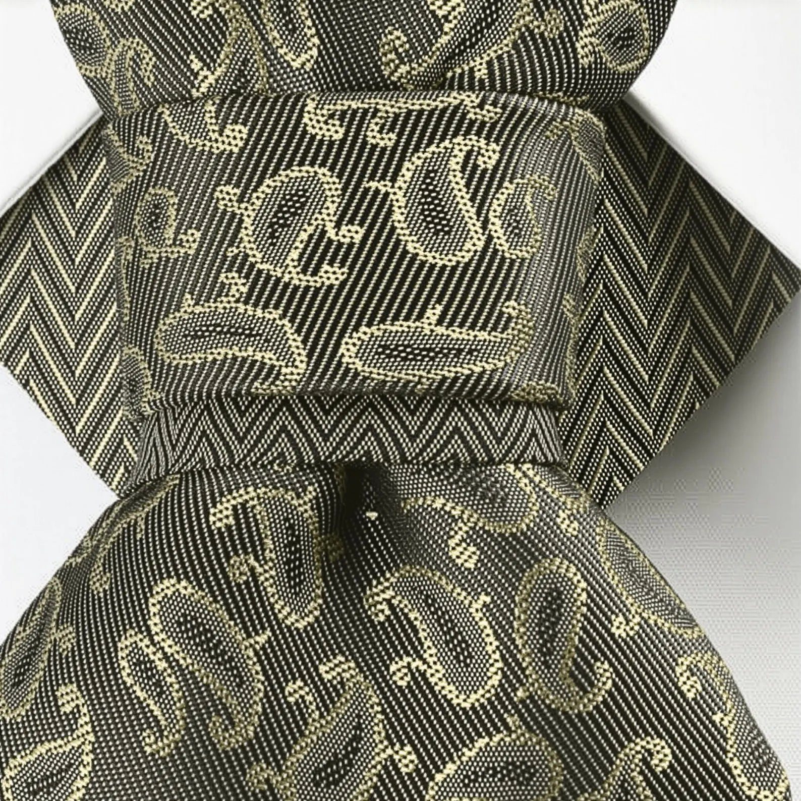 Black and gold patterned fabric with a bow on a white background Bow Tie, Tie for wedding suite SAFARI hopper tie Bow tie 
A black and gold silk ascot tie with a detailed paisley pattern, worn with a classic white dress shirt. The tie features a chevron stripe texture, creating a sophisticated and formal look. It's a handmade luxury wedding accessory