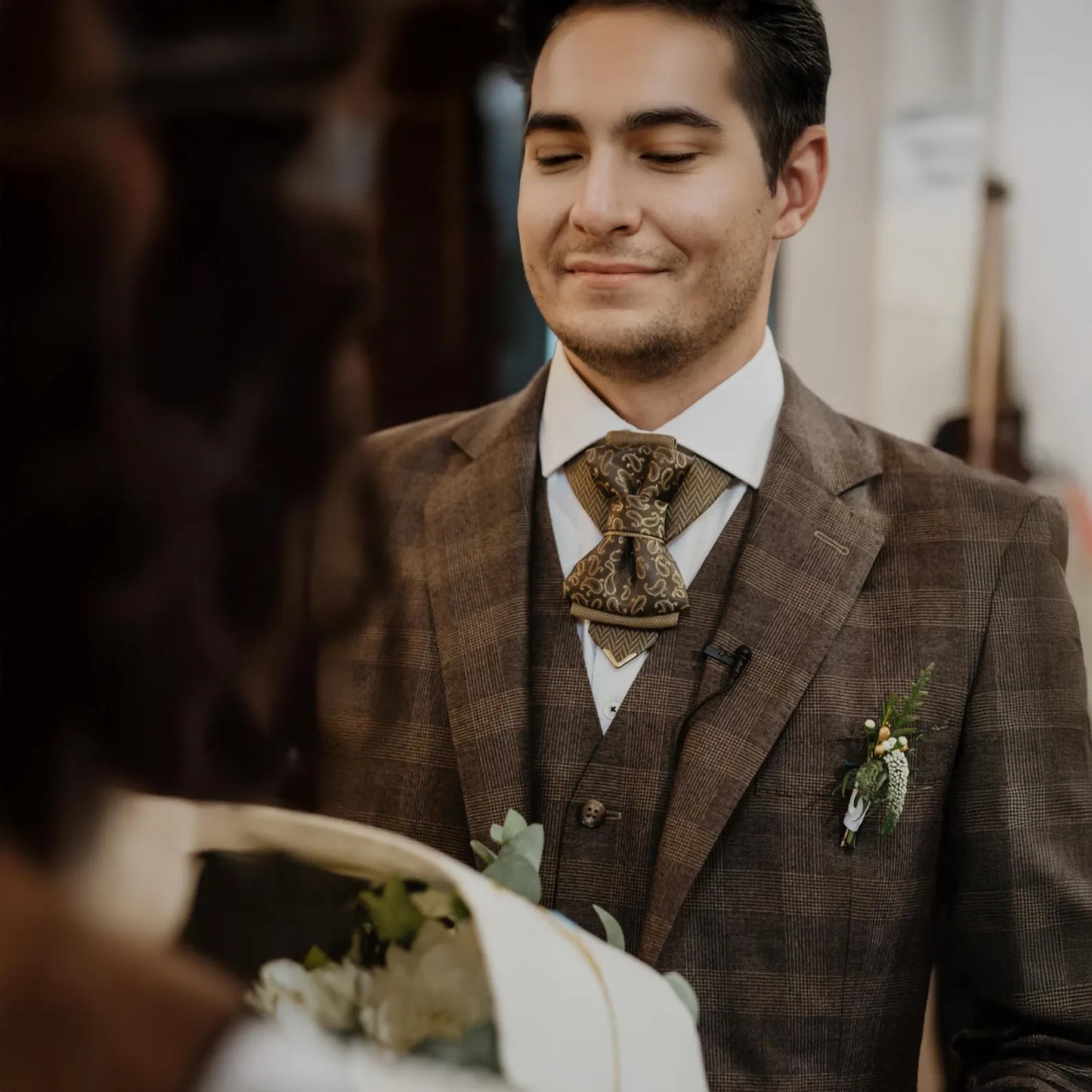 Man in a brown suit with a decorative tie and boutonniere, smiling at a woman. Bow Tie, Tie for wedding suite SAFARI hopper tie Bow tie 
A black and gold silk ascot tie with a detailed paisley pattern, worn with a classic white dress shirt. The tie features a chevron stripe texture, creating a sophisticated and formal look. It's a handmade luxury wedding accessory