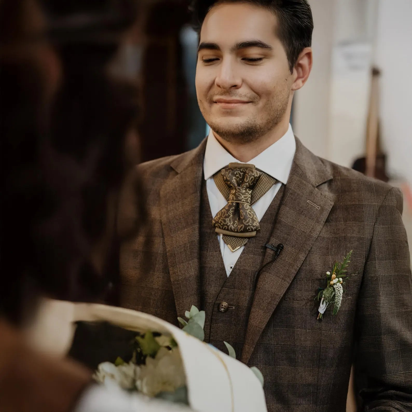 Man in a brown suit with a decorative tie and boutonniere, smiling at a woman. Bow Tie, Tie for wedding suite SAFARI hopper tie Bow tie 
A black and gold silk ascot tie with a detailed paisley pattern, worn with a classic white dress shirt. The tie features a chevron stripe texture, creating a sophisticated and formal look. It's a handmade luxury wedding accessory
