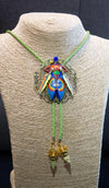 Colorful beetle-shaped pendant on a green cord displayed on a mannequin Luxury art pendant for special occasions, Sophisticated wearable art jewelry styling, Unique gift for art lover woman, Meaningful original art gift for her, Collector miniature painting jewelry piece, One of a kind handmade pendant gift idea, Artistic luxury jewelry for refined taste, Exclusive author jewelry by Marijus Piekuras