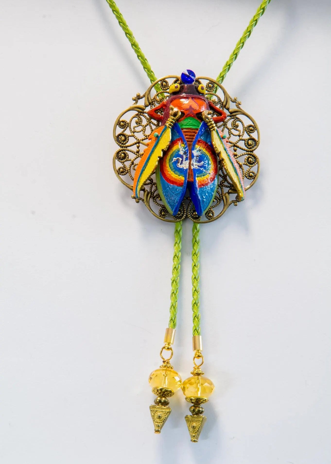 Colorful bolo tie with decorative pendant on a white background Luxury art pendant for special occasions, Sophisticated wearable art jewelry styling, Unique gift for art lover woman, Meaningful original art gift for her, Collector miniature painting jewelry piece, One of a kind handmade pendant gift idea, Artistic luxury jewelry for refined taste, Exclusive author jewelry by Marijus Piekuras