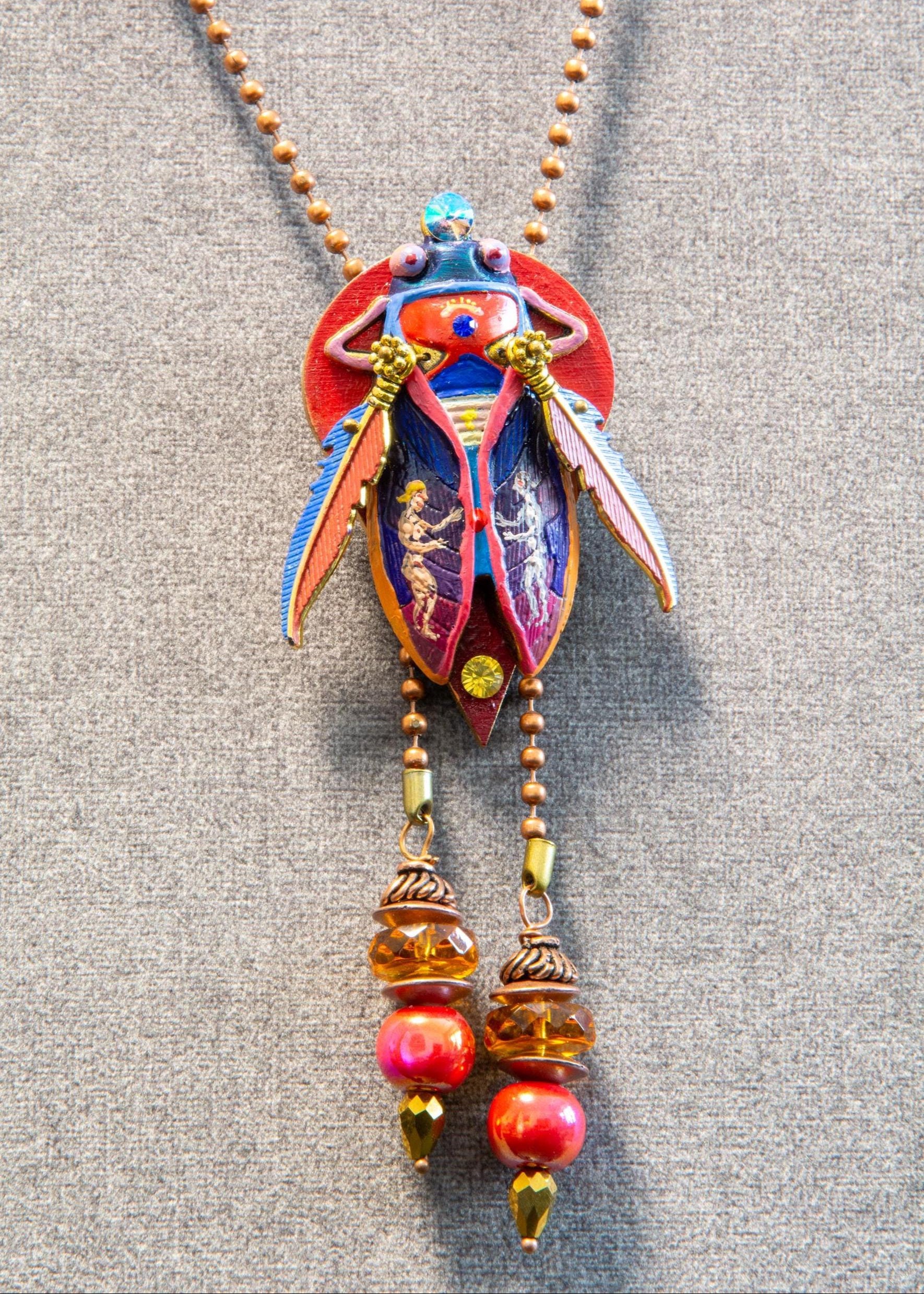 Colorful necklace with decorative pendant on a gray background unique gift for her, art lover gift, handmade jewelry gift, collectible art necklace, luxury statement gift, anniversary gift idea, birthday gift for wife, gift for creative woman, meaningful artistic jewelry, museum style pendant gift, renaissance inspired necklace, fantasy insect jewelry, heirloom style accessory, artisan designer necklace, special occasion jewelry, romantic gift idea, Christmas gift for her, Valentine gift jewelry, one of a k
