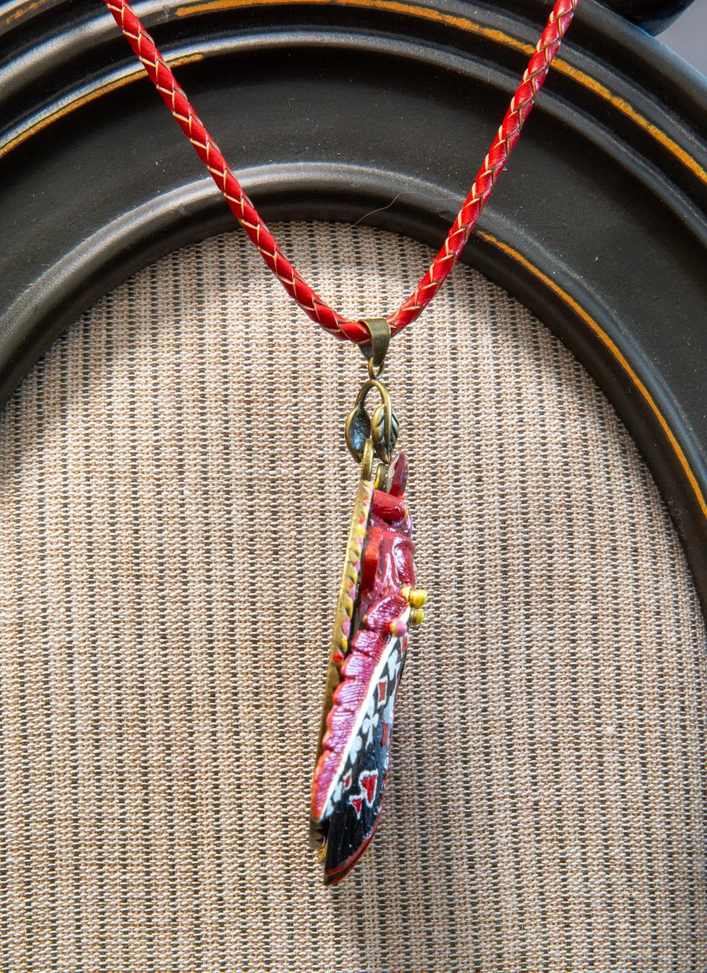 Necklace with a colorful pendant on a textured surface