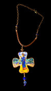 Decorative cross pendant with a figure on a chain against a black background Decorative cross-shaped pendant with a figurine on a dark background Unique artistic pendant for elegant woman, Hand painted miniature art pendant for women one of a kind jewelry, Luxury OOAK miniature painting necklace close up, Original artwork pendant by artist Marijus Piekuras, Fine art wearable pendant handcrafted detail, Tiny original painting inside pendant frame, Woman wearing one of a kind miniature pendant