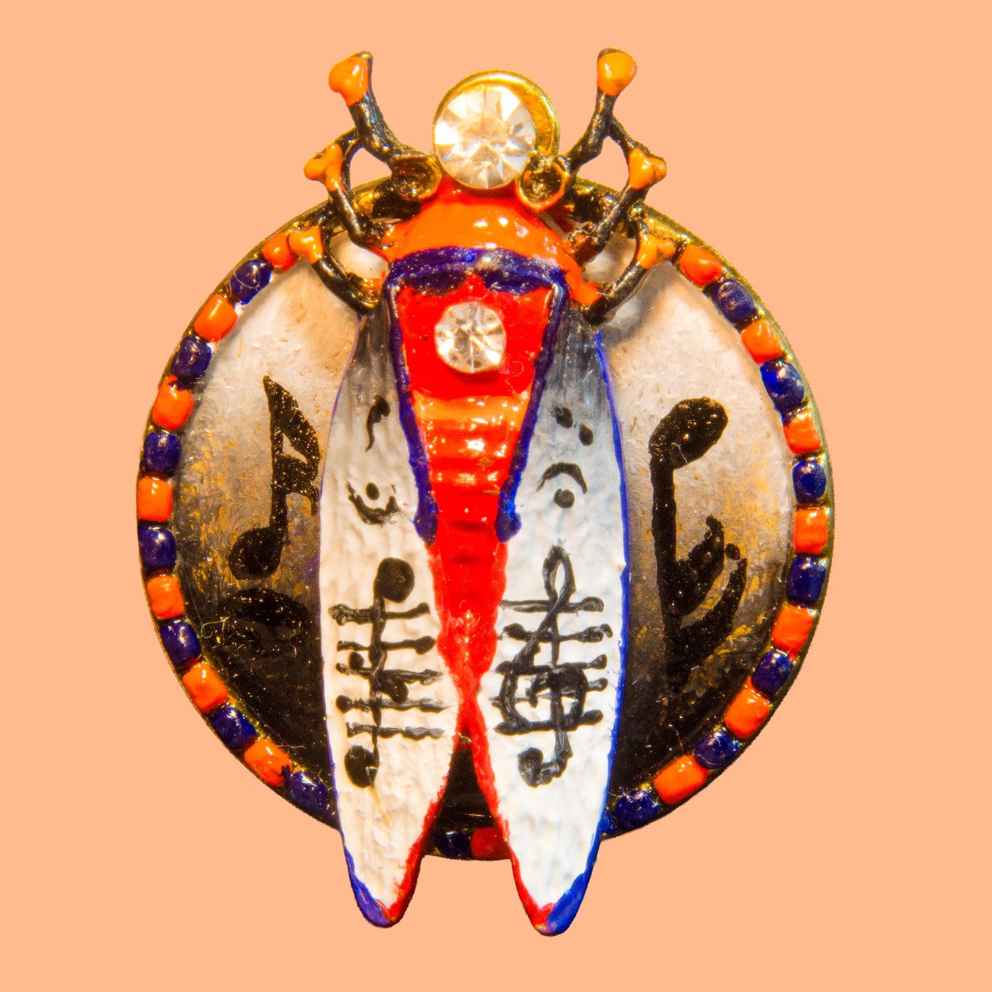 Decorative pendant with musical notes and Chinese characters on a peach background hand painted insect brooch, enamel beetle brooch, cicada brooch jewelry, rhinestone insect brooch, colorful bug brooch, artistic insect pin, handmade enamel brooch, statement insect jewelry, unique bug brooch, designer insect brooch, red black white beetle brooch, decorative insect pin, nature inspired brooch, collectible insect jewelry, whimsical bug brooch, vintage style insect brooch, artistic enamel insect pin, crystal in
