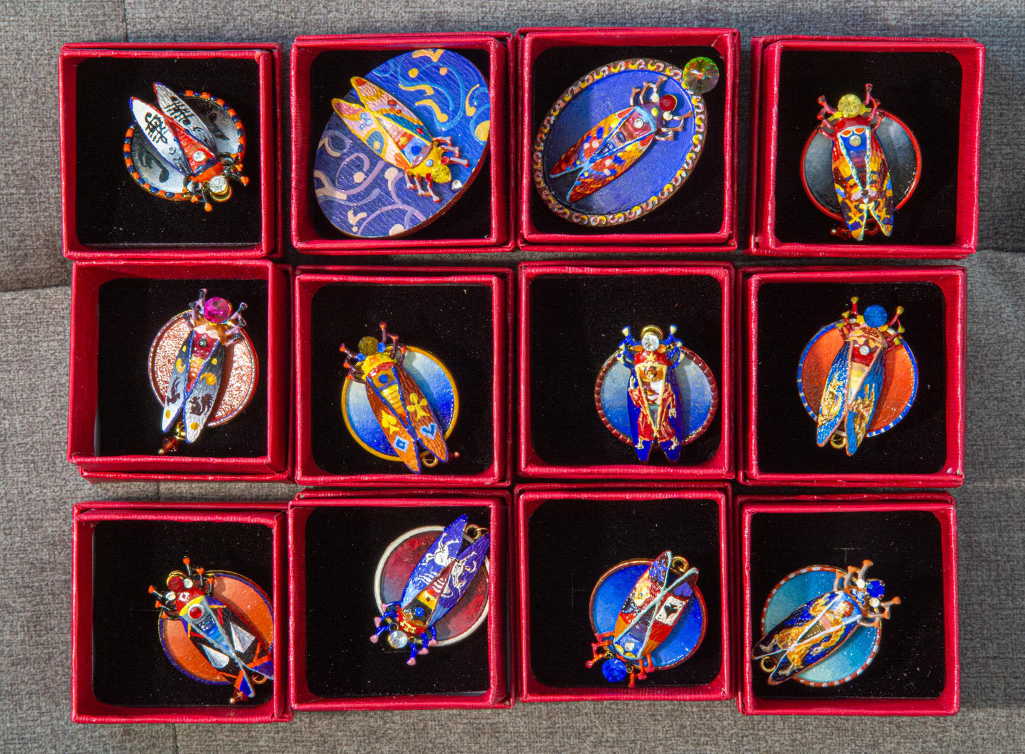 Set of decorative items in red boxes on a textured surface