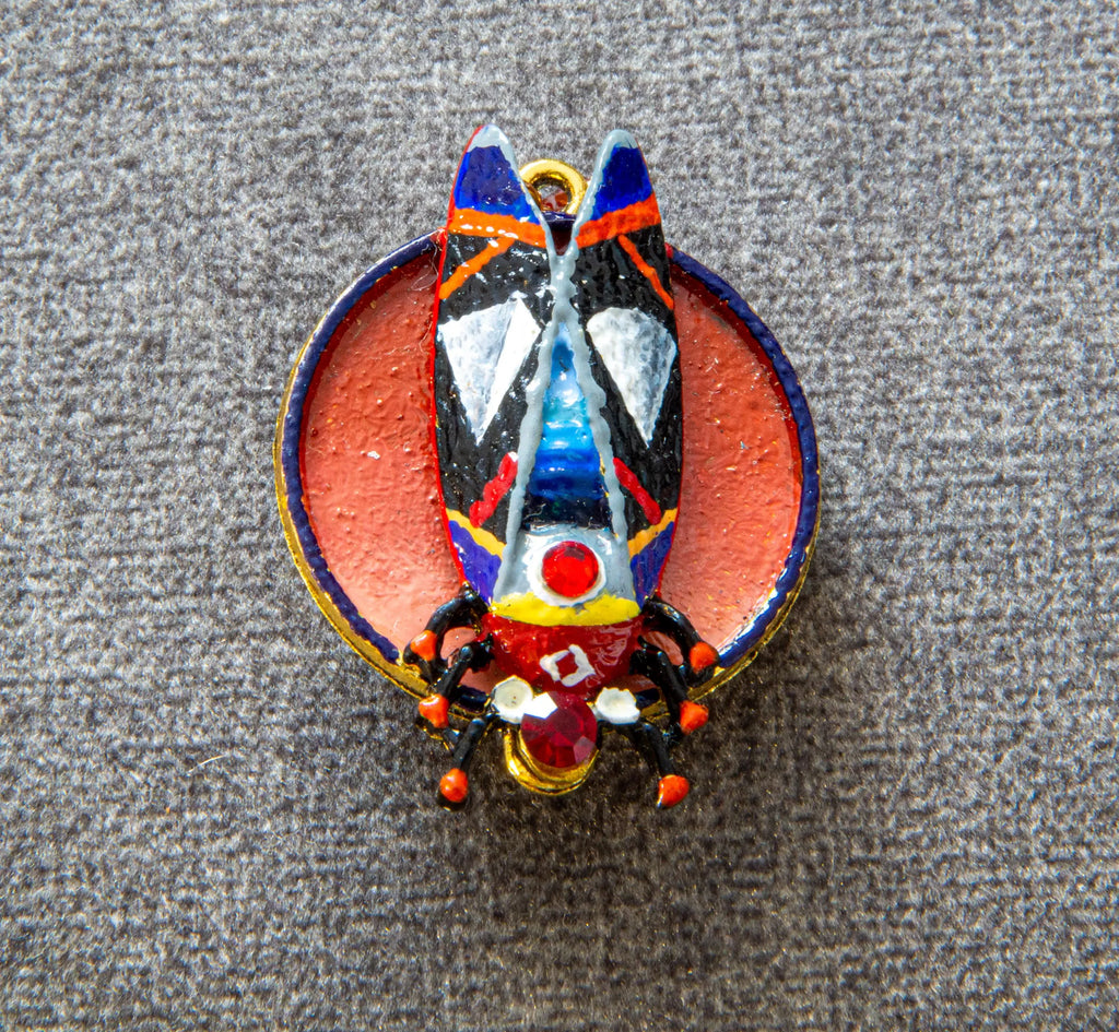Colorful butterfly-shaped pendant on a textured gray background hand painted scarab brooch red black beetle pin, unique artist statement jewelry, one of a kind wearable art brooch, luxury enamel insect pin, bold red black scarab accessory, handmade artistic beetle badge, sculptural statement brooch for blazer, collectible art lover gift jewelry, textured enamel scarab pin, designer insect brooch with gold accents, contemporary art jewelry piece, high quality handmade brooch, distinctive fashion statement pi