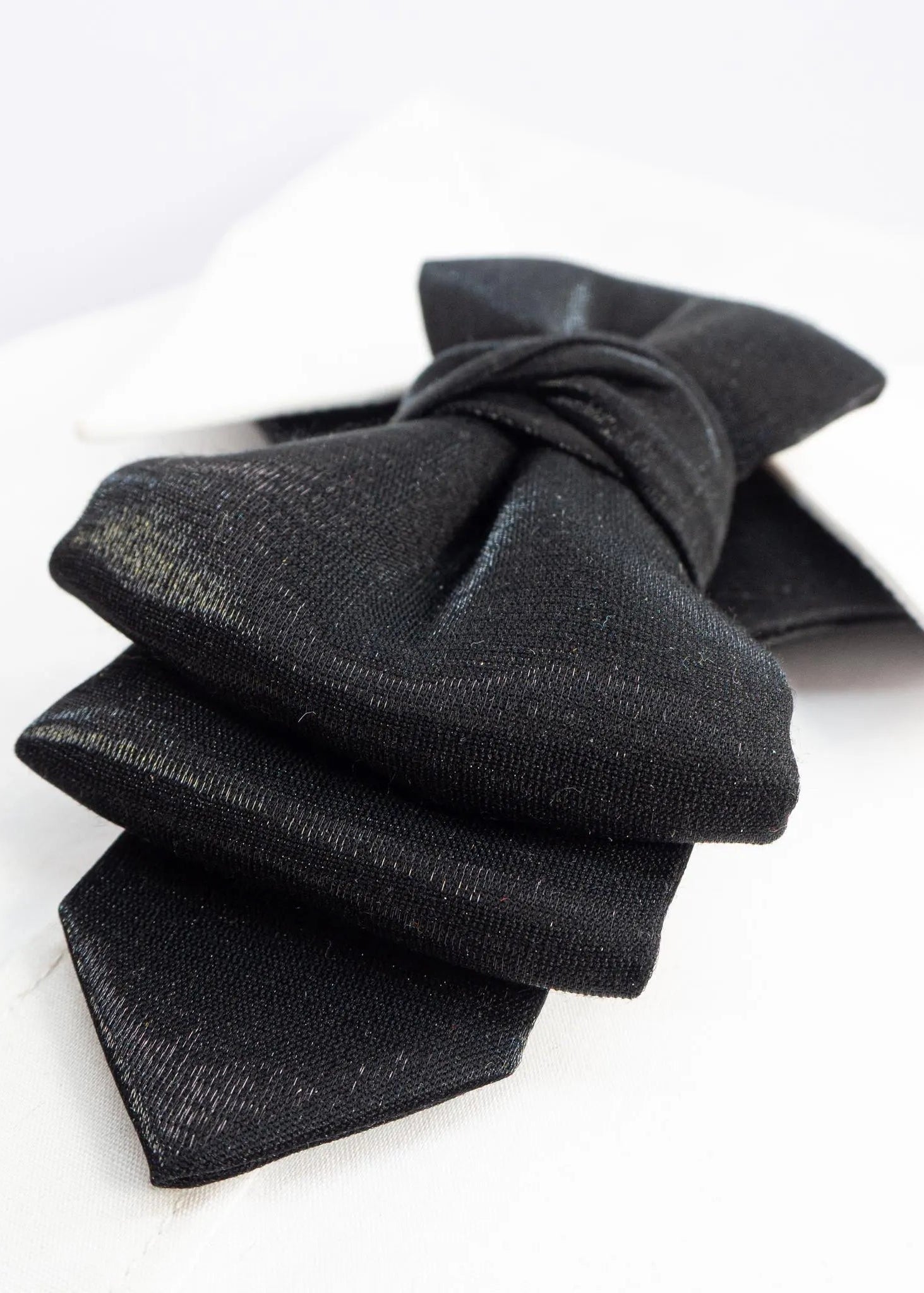 Black bow tie on a white background black statement tie for men, sculptural bow tie alternative, unique formal neckwear, artistic groom tie, modern wedding tie, luxury handmade necktie, sophisticated men fashion, elegant men accessory, designer neckwear piece, standout wedding look, contemporary cravat style tie, tailored suit accessory, refined black necktie, avant garde tie, formal event accessory, minimalist black tie, premium fabric tie, stylish groom outfit detail