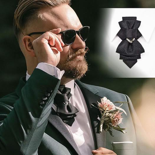 Man in formal attire with a black bow tie and sunglasses, inset showing a close-up of the bow tie Man in a formal suit standing in a train station Handmade luxury black bow tie for weddings, Black wedding bow tie, Unique artistic black necktie for stylish men, Designer black bow tie for grooms and musicians, Elegant black wedding bow tie by Rūta Piekurienė, High-end handmade black tie for special occasions, Artistic luxury black bow tie for men, Unique wedding bow tie crafted by Rūta Piekurienė, Handmade bl