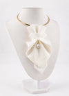 A white textured fabric bow collar necklace with a small pearl drop and gold metal accents, displayed on a white mannequin bust Luxury handmade white textile neck accessories for women displayed on soft ivory fabric. Elegant designer statement chokers featuring textured fabric, satin bows, and a pearl pendant, handcrafted for brides, weddings, bridal showers, formal occasions, and timeless fashion. Premium artisan accessories showcasing matching bridal and minimalist designs with couture-inspired craftsmans