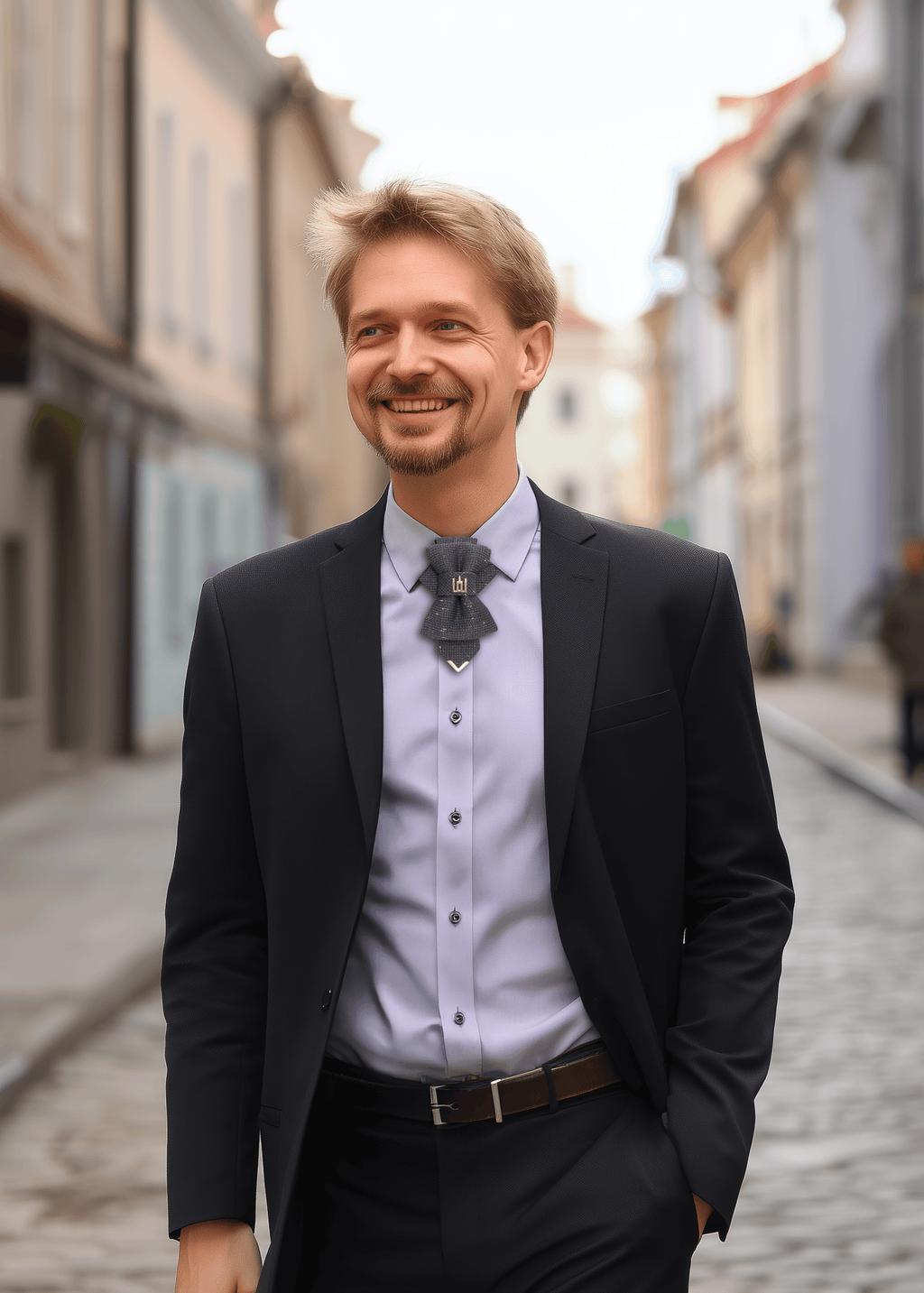 Man in a suit standing on a street with buildings in the background Handmade luxury tie featuring Gediminas Columns emblem, elegant jabot-style design in dark shimmering fabric with gold and purple accents. A unique artisan necktie for weddings, concerts, cultural events, and special occasions. Ideal unisex accessory symbolizing heritage, strength, and individuality.