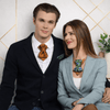 Man and woman sitting together wearing large bow ties against a geometric patterned wall Elegant bowtie for men, Unique tie for cavaliers, stylish wedding necktie, Gift for stylish men vertical bow tie, hopper tie, sculptural tie, artistic necktie, designer bow tie, modern cravat, avant garde tie, unique mens tie, statement neckwear, burnt orange tie, copper silk tie, luxury handmade tie, fashion forward tie, elegant groom tie, wedding statement tie, mens formal accessory, contemporary bow tie, architectura
