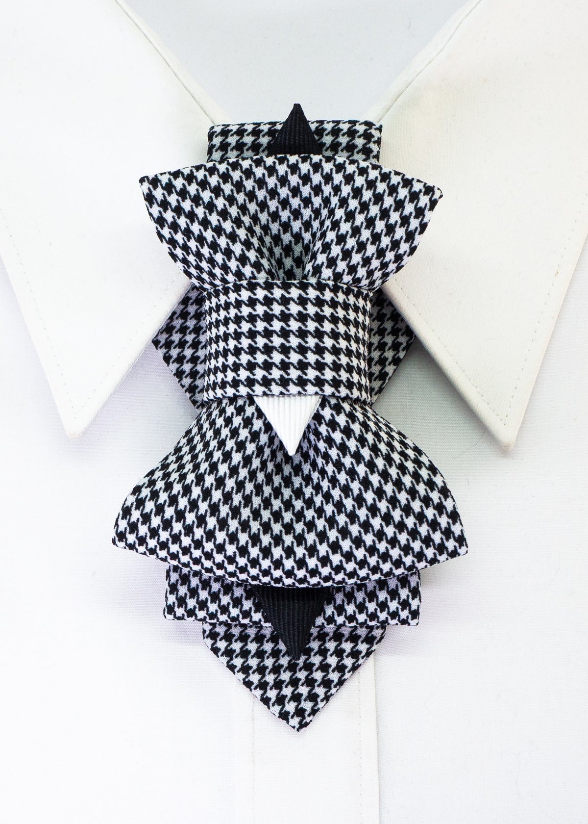 Black and white houndstooth Bow Tie vertical bow tie for women, shown from the front beneath a white shirt collar.