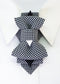 Black and white houndstooth Bow Tie vertical bow tie for women, shown from the front beneath a white shirt collar.